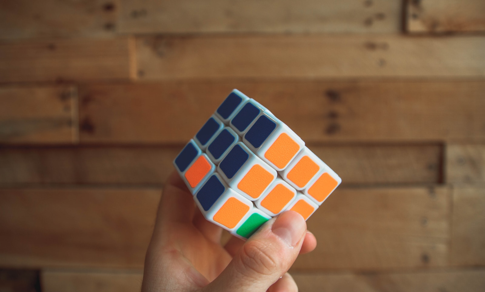 Photo by Kenny Eliason person holding 3x3 Rubik's Cube