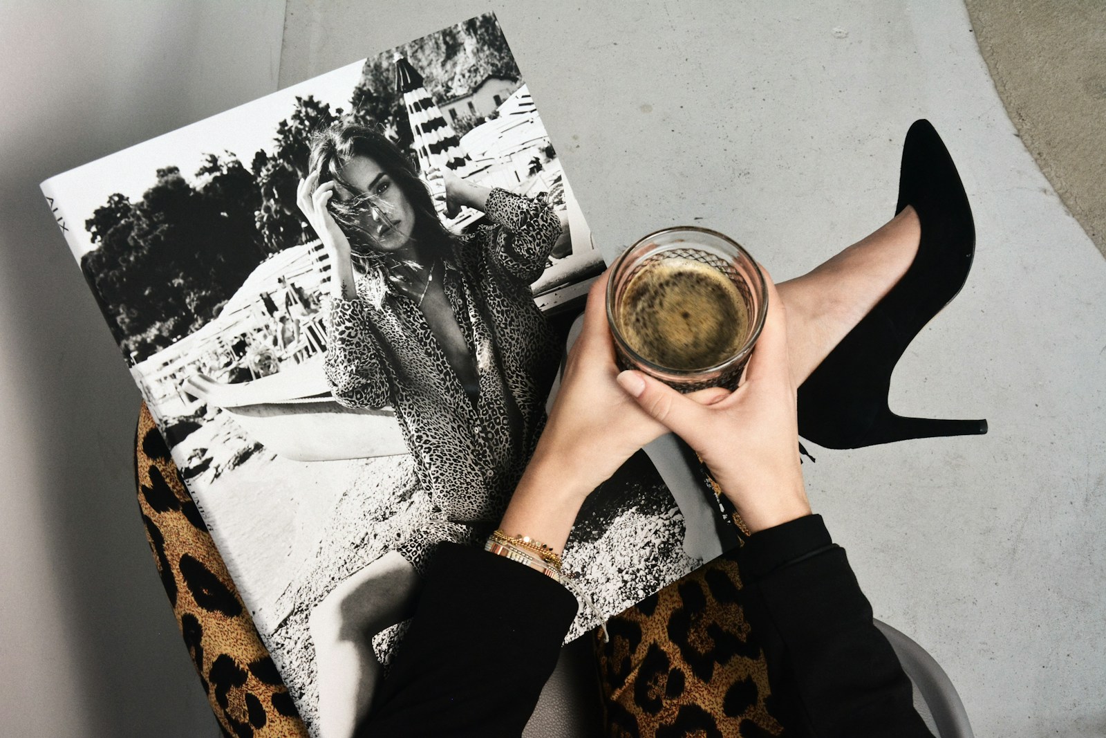 Photo by Cleo Vermij woman holding clear glass candle holder and grayscale portrait of a woman